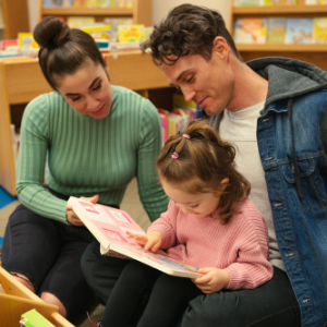 mom and dad reading to toddler