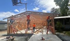 Illinois Valley branch under construction. Construction workers in orange shirts framing structure